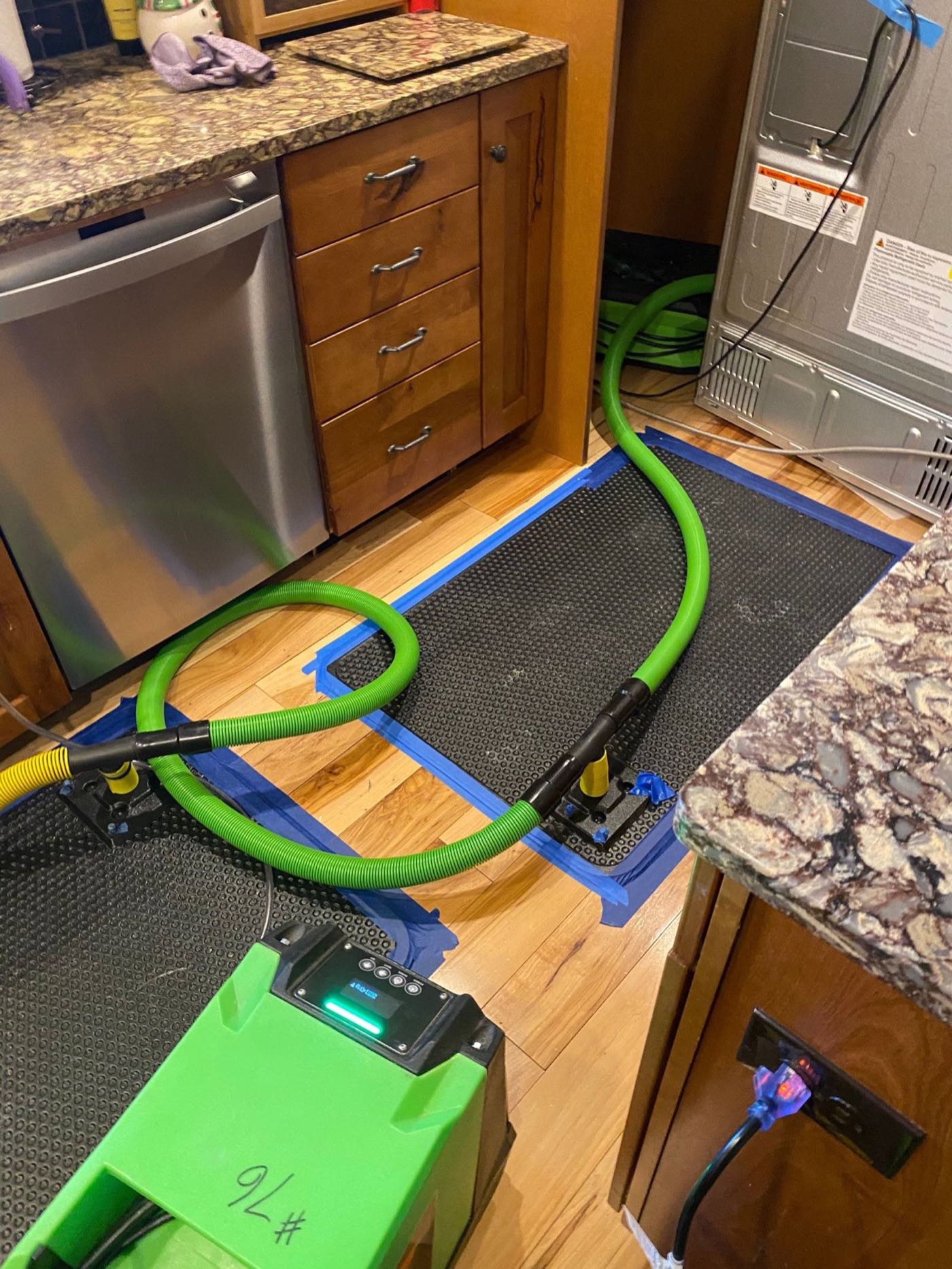 Leaking water heater with water pooling on the floor