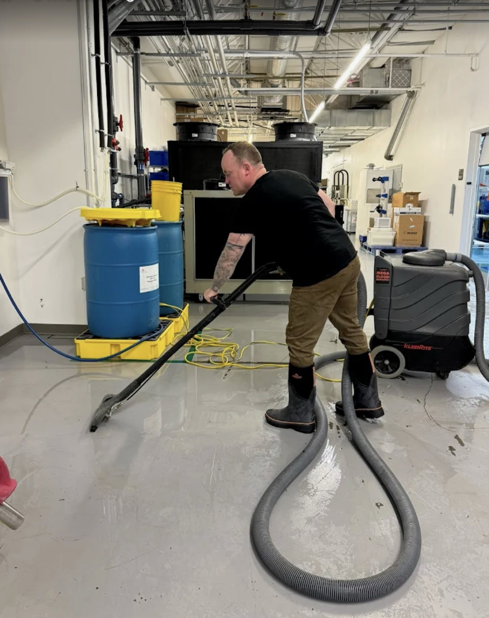 Professional sewage cleanup with safety equipment