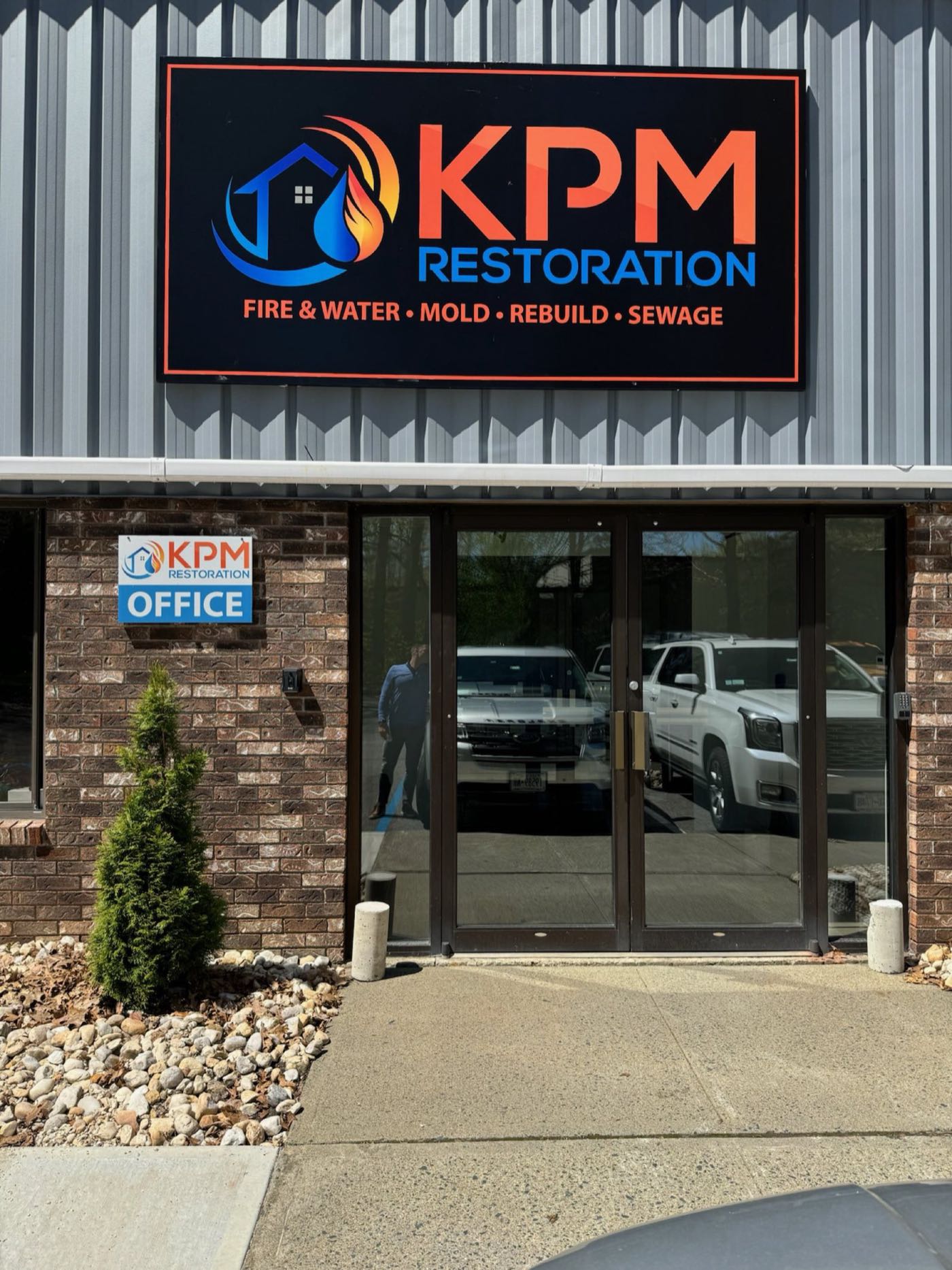 Homeowner cleaning gutters during spring maintenance