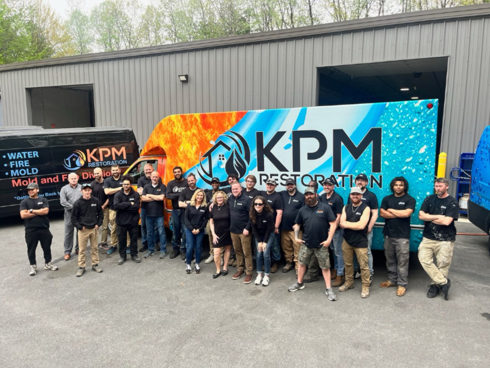 KPM Restoration team celebrating Brawny Giant recognition